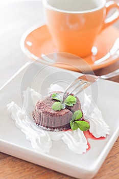 Chocolate lava cake with fork and coffee cup