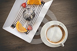 Chocolate lava cake with fresh fruit and coffee