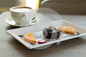 Chocolate lava cake with fresh fruit and coffee