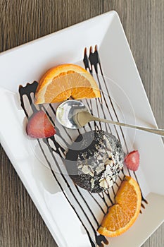 Chocolate lava cake with fresh fruit and coffee