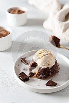 Chocolate lava cake with ice cream scoop served on plate on white background. Confectionery, cafe, restaurant menu, recipe,