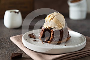 Chocolate lava cake with ice cream served on plate on dark background. Confectionery, cafe, restaurant menu, recipe, cookbook