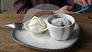 Chocolate Lava Cake With Ice Cream, Served on a White Plate on the wooden table