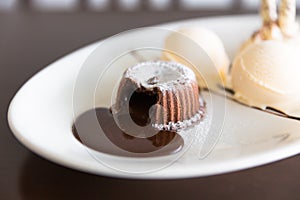 Chocolate lava cake set with ice cream on white plate