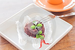 Chocolate lava on white plate and coffee cup