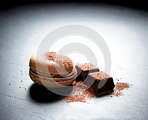 Chocolate macaron at the black background
