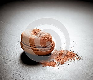 Chocolate macaron at the black background