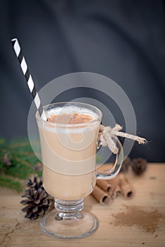Chocolate Martini Cocktail or eggnog with cinnamon and chocolate in glass for Christmas on mahogany background