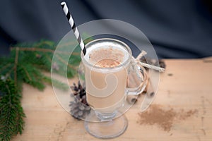 Chocolate Martini Cocktail or eggnog with cinnamon and chocolate in glass for Christmas on mahogany background