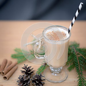 Chocolate Martini Cocktail or eggnog with cinnamon and chocolate in glass for Christmas on mahogany background