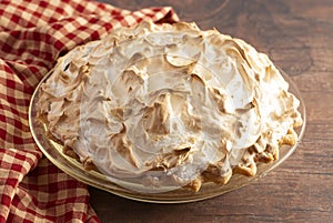 A Chocolate Meringue Pie on a Rustic Wooden Table