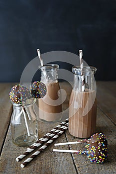 Chocolate milk with cake pops and straws