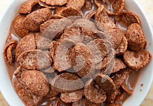 Chocolate milk with cereal slices close up as healthy eating