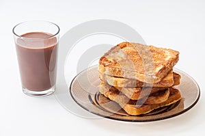 Chocolate milk and french toast arranged on a plate