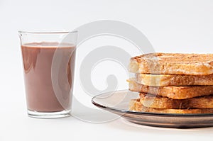 Chocolate milk and french toast arranged on a plate