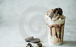 Chocolate milk shakes with cinnamon, chocolate pieces and various spices on stone background