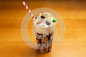 Chocolate milkshake with caramel on a wooden table