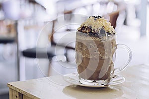 Chocolate Milkshake with chocolate cereals, cheese, and Choco chips in the big clear glass cup. Selective focus close-up on top of