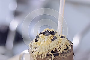 Chocolate Milkshake with chocolate cereals  cheese  and Choco chips in the big clear glass cup. Selective focus close-up on top of