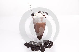 Chocolate milkshake with chunks of chocolate and cookies on top,