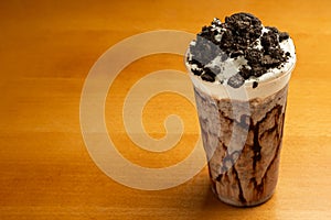 Chocolate milkshake with cookies on a wooden table