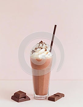 Chocolate milkshake with cream and drinking straw on colorful background