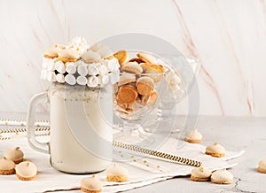 Chocolate milkshake decorated with marshamallows and cookies