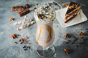 Chocolate milkshake with whipped cream, chocolate and cake.