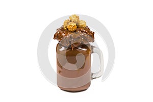 Chocolate milkshake with whipped cream, cookies, waffles, served in glass mason jar.