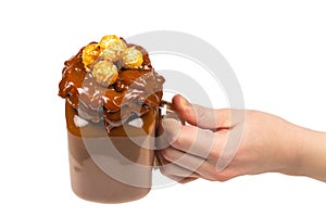 Chocolate milkshake with whipped cream, cookies, waffles, served in glass mason jar.