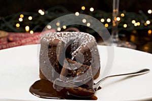 CHOCOLATE MOLTEN LAVA CAKE DECORATED WITH ICING SUGAR ON A WHITE