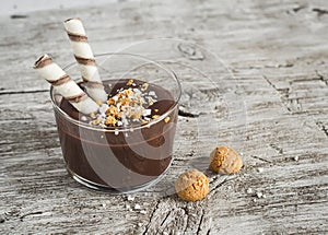 Chocolate mousse with biscuits in glass beakers