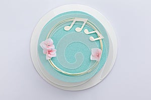 Chocolate mousse cake on a white background top view. Cake for a musician`s birthday