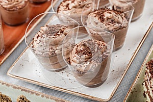 Chocolate mousse dessert with cocoa in glass on holiday background. Delicious dessert and candy bar