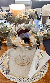 Chocolate mousse dessert and whipped cream with gold dust on a fancy crystal glass