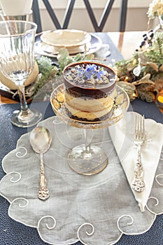 Chocolate mousse dessert and whipped cream with gold dust on a fancy crystal glass dish