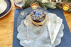 Chocolate mousse dessert and whipped cream with gold dust on a fancy crystal glass dish