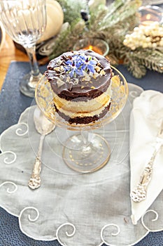 Chocolate mousse dessert and whipped cream with gold dust on a fancy crystal glass dish