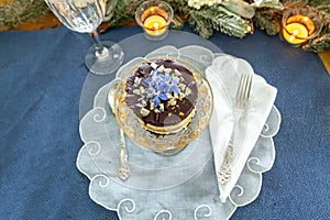 Chocolate mousse dessert and whipped cream with gold dust on a fancy crystal glass dish