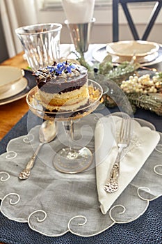 Chocolate mousse dessert and whipped cream with gold dust on a fancy crystal glass dish