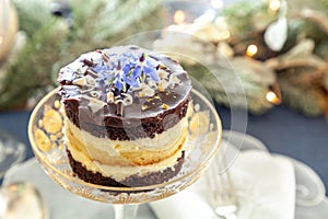 Chocolate mousse dessert and whipped cream with gold dust on a fancy crystal glass dish