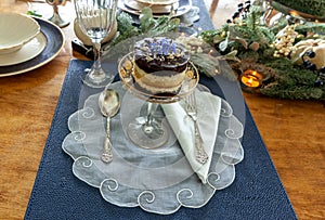 Chocolate mousse dessert and whipped cream with gold dust on a fancy crystal glass dish