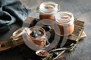 Chocolate mousse in glass jar with berries