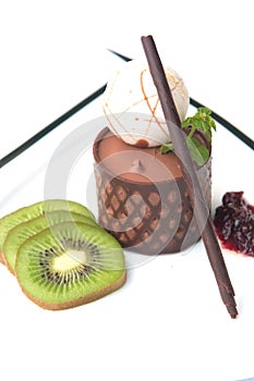 chocolate mousse presented with a scoop of ice cream and natural kiwi