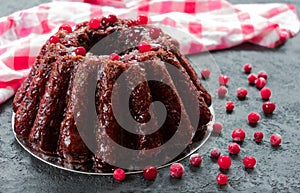 Chocolate muffin with cherry, cranberry and lecker on a white wooden background. Close-up.