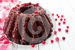 Chocolate muffin with cherry, cranberry and lecker on a white wooden background. Close-up. photo