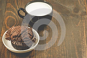 Chocolate muffin and milk/chocolate muffin and milk on a wooden background. Copy space