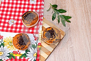 Chocolate muffin and nut muffin, homemade bakery on dark background. Muffin with blueberries on a wooden table.