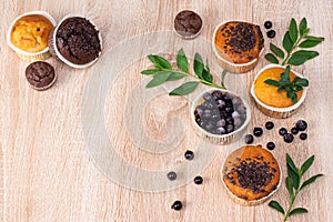 Chocolate muffin and nut muffin, homemade bakery on dark background. Muffin with blueberries on a wooden table.