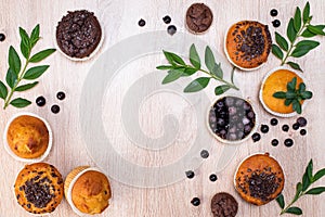 Chocolate muffin and nut muffin, homemade bakery on dark background. Muffin with blueberries on a wooden table.